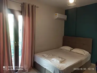 a small bedroom with a bed with a window at Παιδων στουντιο 3 in Athens