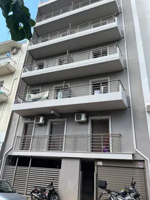 two motorcycles parked in front of a building at Παιδων στουντιο 3 in Athens