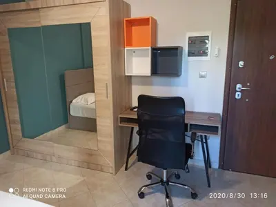 a small room with a desk and a bedroom at Παιδων στουντιο 3 in Athens