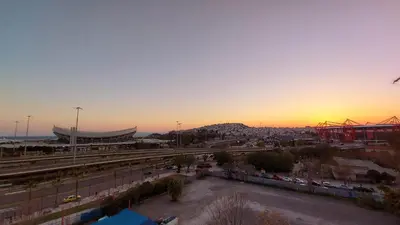 a sunset over a stadium with a parking lot at METROPOLITAN MACVIEW-3 διαμέρισμα studio Φάληρο in Piraeus