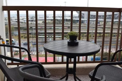 a table with a plant sitting on top of a balcony at METROPOLITAN MACVIEW-3 διαμέρισμα studio Φάληρο in Piraeus