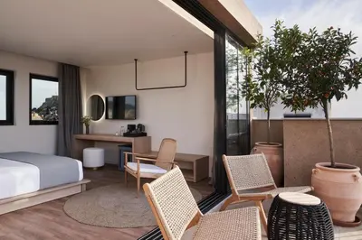 a bedroom with a bed and chairs and a desk at Vasi in Athens
