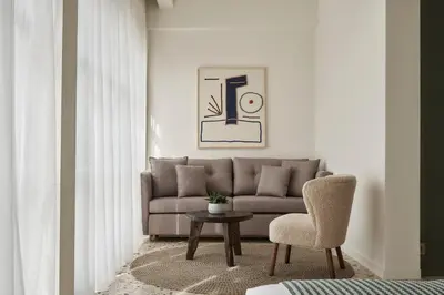 a living room with a couch and a table and a chair at Vasi in Athens
