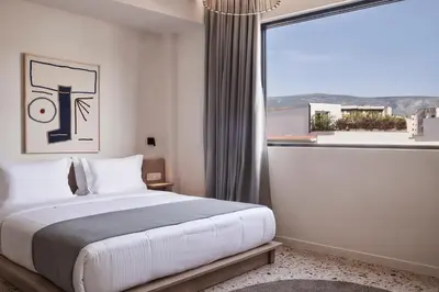 a bedroom with a bed and a large window at Vasi in Athens
