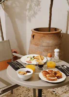a table with plates of breakfast food on it at Vasi in Athens