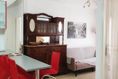 a dining room with a table and a mirror at Ground floor apt with rooftop and stunning view in Athens