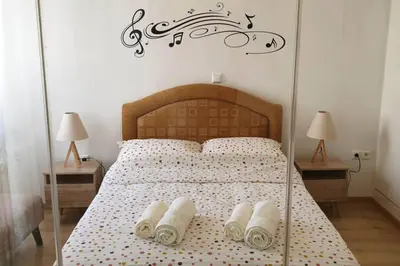 a bedroom with a bed with three towels on it at Ground floor apt with rooftop and stunning view in Athens