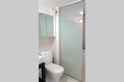 a bathroom with a toilet and a glass shower at Ground floor apt with rooftop and stunning view in Athens