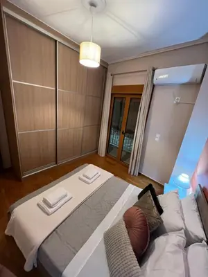 a room with a bed and a couch in it at Alimos Cozy Getaway, close to the beach in Athens