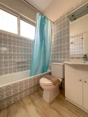 a bathroom with a toilet and a tub and a sink at Cassiopeia - Glyfada Apartment in Athens