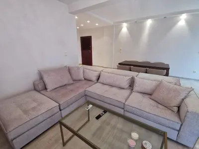 a living room with a couch and a table at Cassiopeia - Glyfada Apartment in Athens