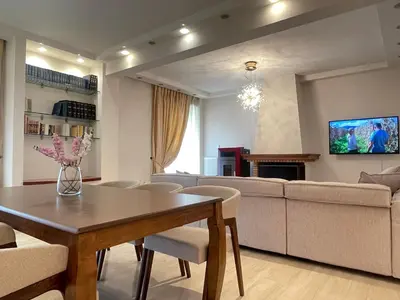 a living room with a table and a couch at Cassiopeia - Glyfada Apartment in Athens