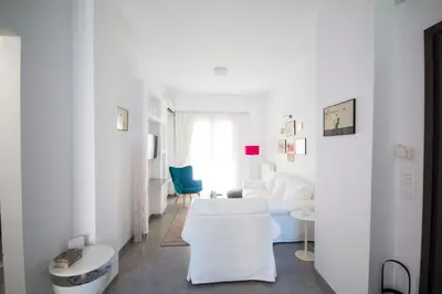 a white living room with a couch and a table at Marina's Luxury Apartment close to Acropolis in Athens