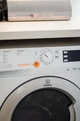 a washing machine with a microwave on top of it at Marina's Luxury Apartment close to Acropolis in Athens