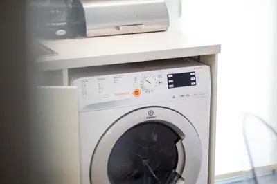 a washing machine in a kitchen with a microwave at Marina's Luxury Apartment close to Acropolis in Athens
