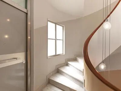 a winding staircase in a house with a window at The Prestige Acropolis Penthouse in Athens