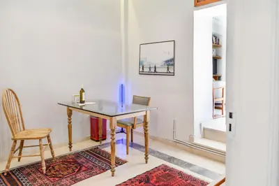 a dining room with a table and a chair at Athenian Yard Near Acropolis in Athens