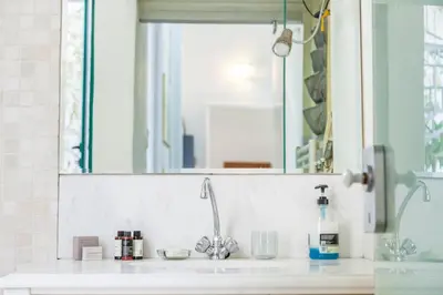 a bathroom counter with a sink and a mirror at Athenian Yard Near Acropolis in Athens