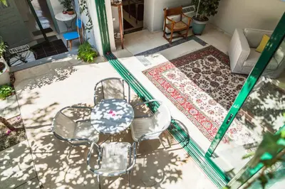 an aerial view of a patio with a table and chairs at Athenian Yard Near Acropolis in Athens