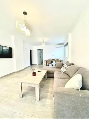 a living room with a couch and a table at The Aegean Nest in Athens