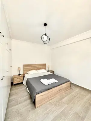 a bedroom with a bed with two towels on it at The Aegean Nest in Athens