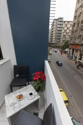a balcony with a table and a view of a street at Evita Asty in Athens