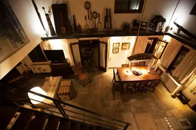 an overhead view of a living room with a table and chairs at villa eleni in Sounio