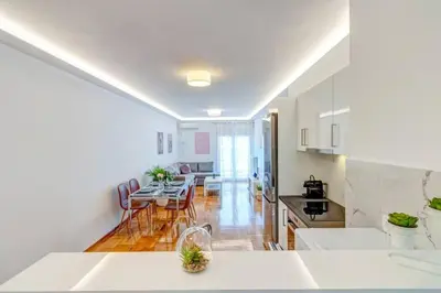 a kitchen and living room with a table and chairs at Koukaki lux 2BD 1master ap next to Acropolis in Athens