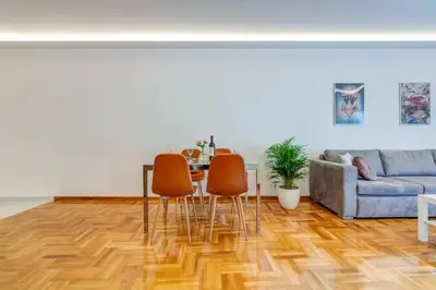 a living room with a table and chairs and a couch at Koukaki lux 2BD 1master ap next to Acropolis in Athens