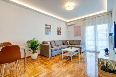 a living room with a couch and a table at Koukaki lux 2BD 1master ap next to Acropolis in Athens