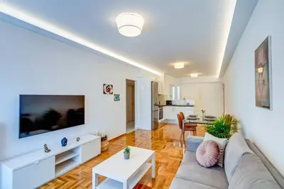 a living room with a couch and a table at Koukaki lux 2BD 1master ap next to Acropolis in Athens