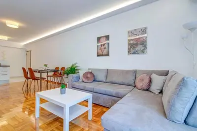 a living room with a couch and a table at Koukaki lux 2BD 1master ap next to Acropolis in Athens