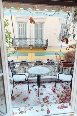 a patio with a table and chairs on a balcony at Magnificent apartment in Plaka in Athens