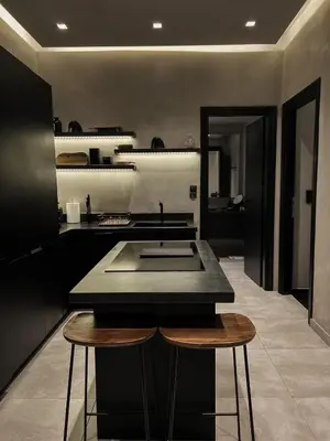 a kitchen with a sink and two stools at CASAGOLD Glyfada Luxury Apartment Near The Sea in Athens