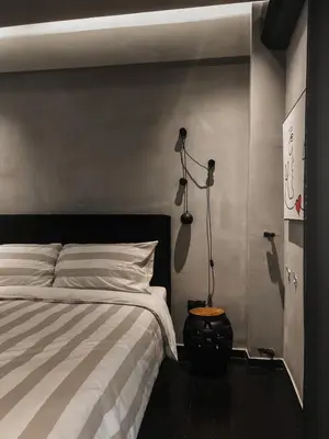 a bedroom with a bed and two lights on the wall at CASAGOLD Glyfada Luxury Apartment Near The Sea in Athens