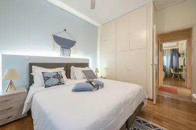 a white bedroom with a large white bed with pillows at Elegant Ariadne, 2 Bedroom Apartment, by Acropolin in Athens