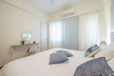 a bedroom with a white bed with two pillows on it at Elegant Ariadne, 2 Bedroom Apartment, by Acropolin in Athens