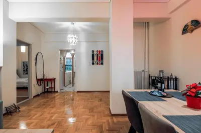 a living room with a table and a wooden floor at Elegant Ariadne, 2 Bedroom Apartment, by Acropolin in Athens