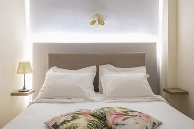 a white bed with two pillows and a headboard at Elegant Ariadne, 2 Bedroom Apartment, by Acropolin in Athens