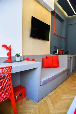 a living room with a couch with orange pillows at CentraL44 LoL RooM-Ermou Street in Athens