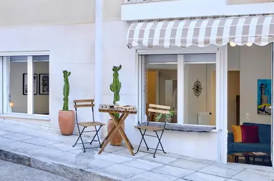 a table and chairs outside of a building at Acropolis 2BD Private Entrance Apt in Athens