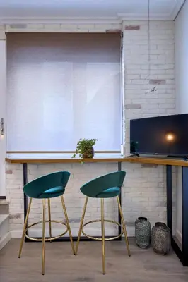 two green chairs sitting in front of a counter at Acropolis 2BD Private Entrance Apt in Athens