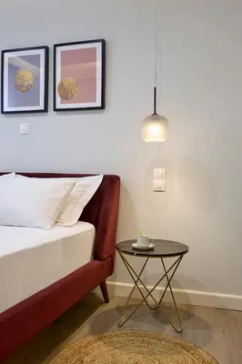 a bedroom with a bed and a table at Acropolis 2BD Private Entrance Apt in Athens
