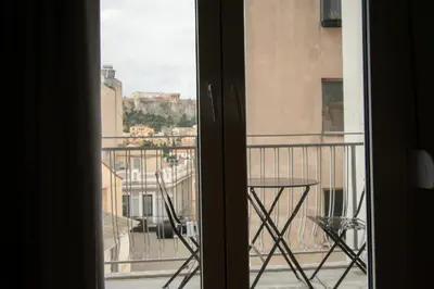 a view from a window of a balcony with a table at Hidden Gem Acropolis View in Athens