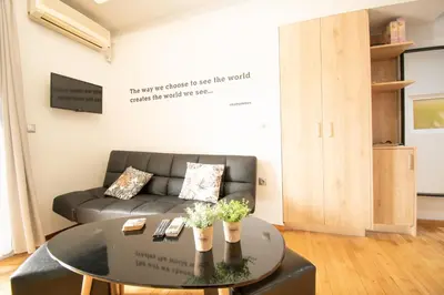 a living room with a couch and a table at Hidden Gem Acropolis View in Athens