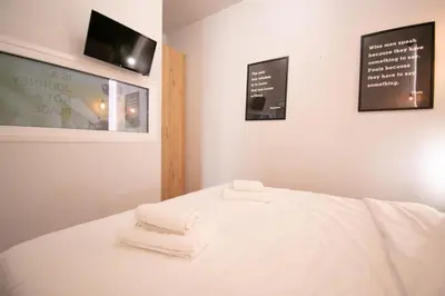 a room with a bed with two towels on it at Hidden Gem Acropolis View in Athens