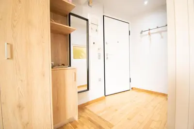 a room with white walls and wood flooring and two large windows at Hidden Gem Acropolis View in Athens