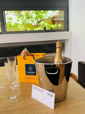 a bottle of champagne in a bucket on a table at Elegant and Private Living by Neuvel in Athens
