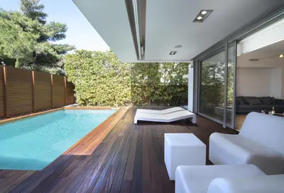 an indoor swimming pool in a house with a living room at Elegant and Private Living by Neuvel in Athens