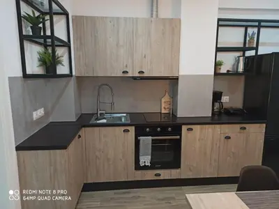 a kitchen with wooden cabinets and a sink at Argous - Athens City Center Apartment in Athens
